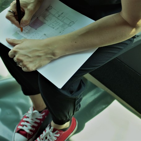 A woman holding the plan for our new headquarters