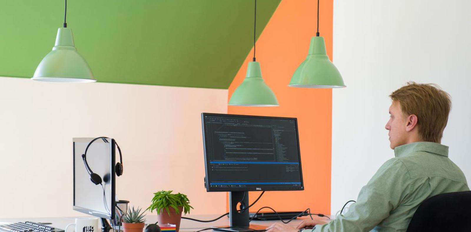 An office setup with a man using a computer.