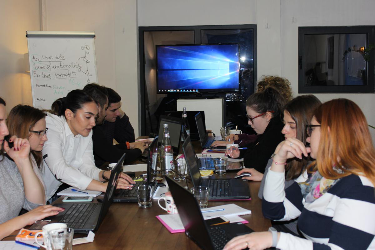 People working on computers during a QA workshop