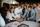 Employees at IBORN.NET gathered around, adding their signatures to a big canvas, symbolizing the mark they left at the company, the teamwork, and shared goals.