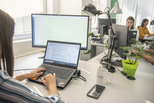 An engineer writing code on a laptop