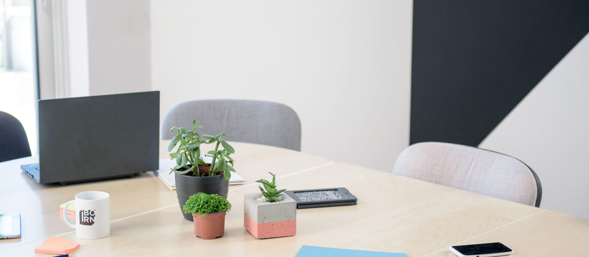 Mobile developers planning and working together in a bright conference room.