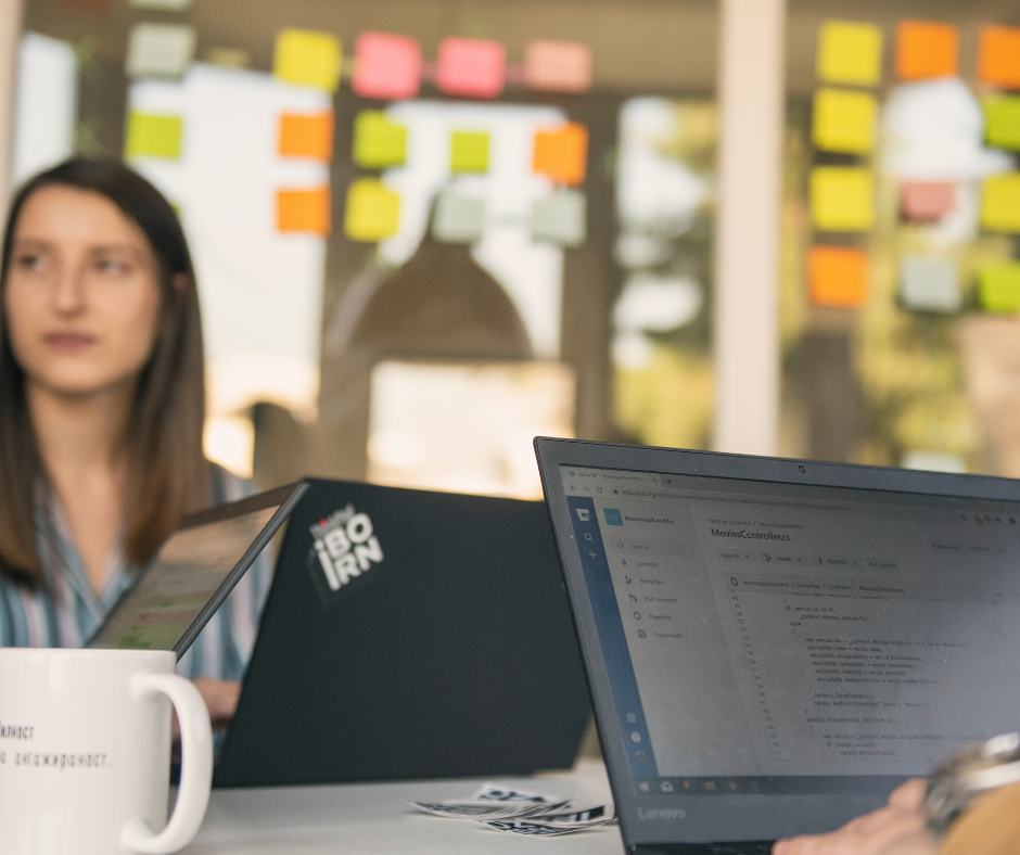 People focused on their laptops, working diligently in a modern office space.