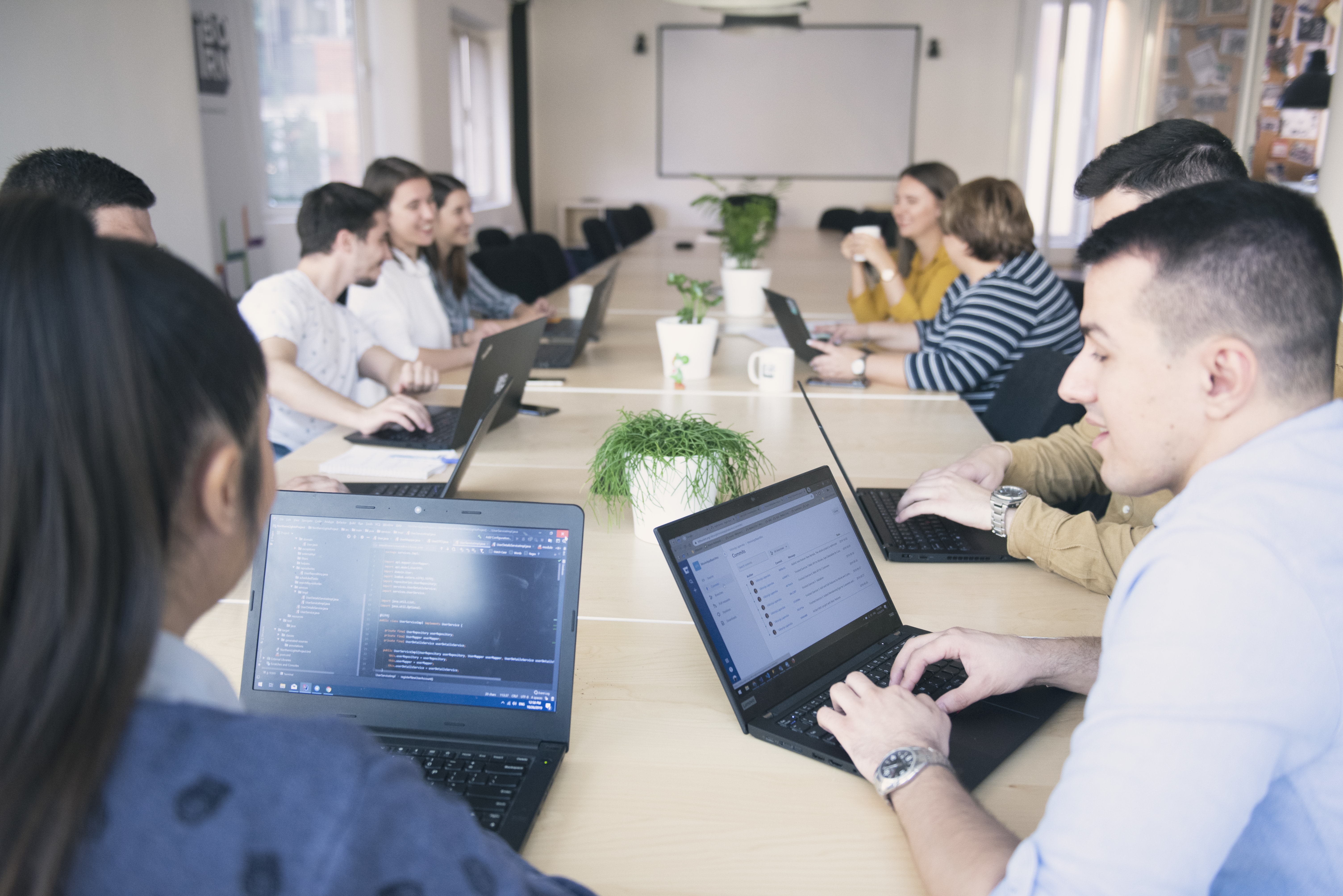 A group of software engineers working in a conference room. 