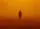 Officer K from Blade Runner 2049 is standing in a dim orange light.