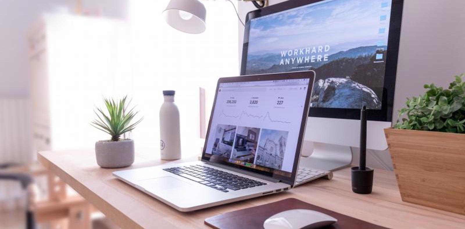 Laptop and a desktop computer on a desk.