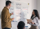 Developer and a designer standing in front of a whiteboard, discussing project wireframes.