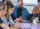 A  group of colleagues sitting at a table with laptops, working together on a project.