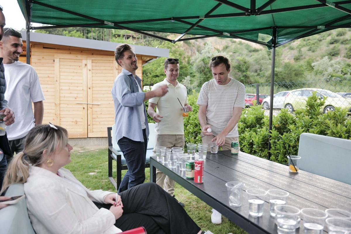People playing beer pong during a founding anniversary picnic party at villa KAE Skopje