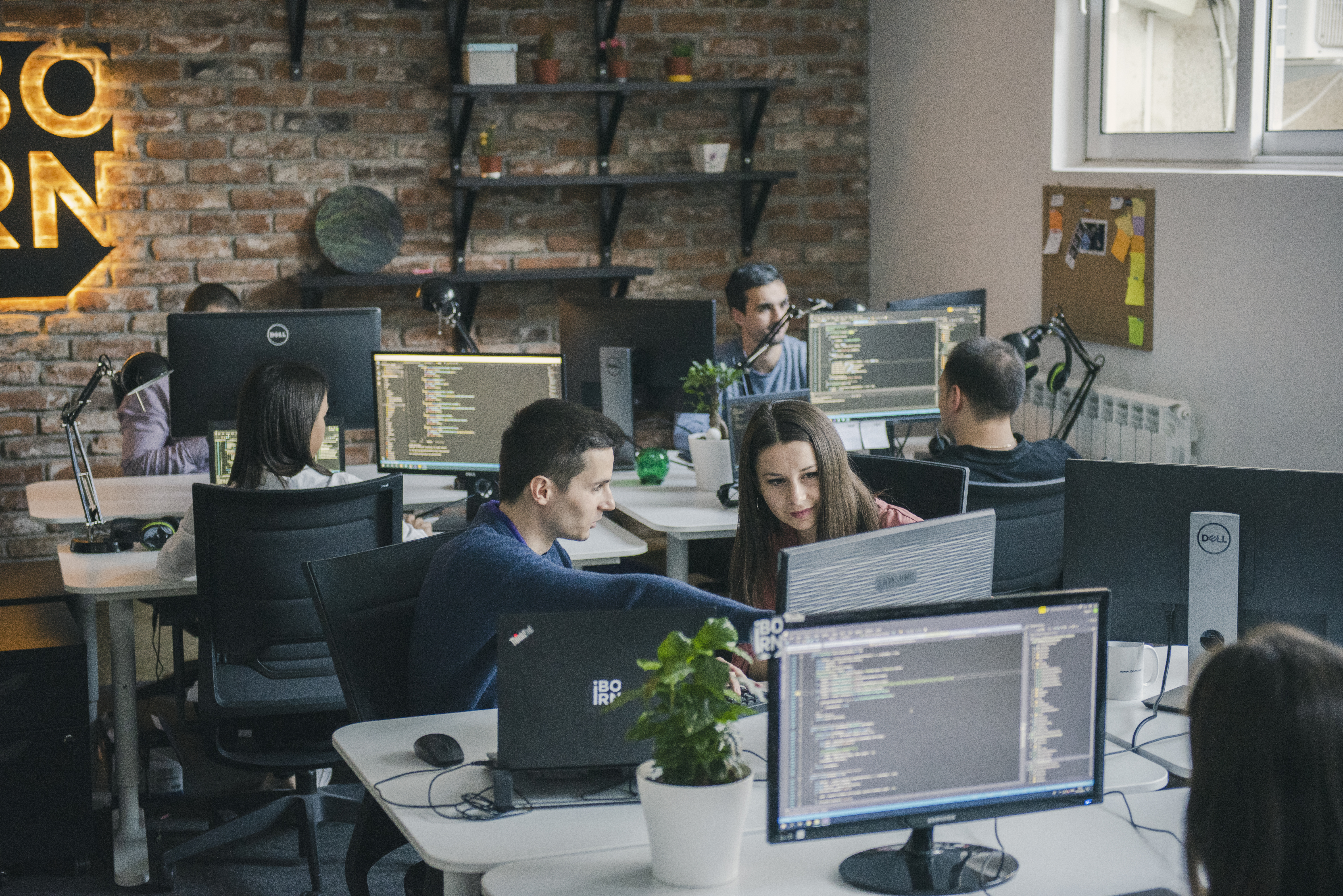 Software engineers working together in a modern office space.