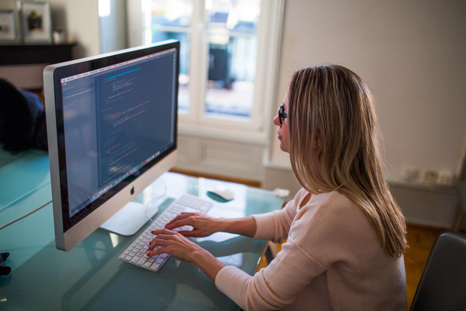 A QA Engineer working on a computer.