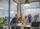 Three men focused on a laptop at a table.