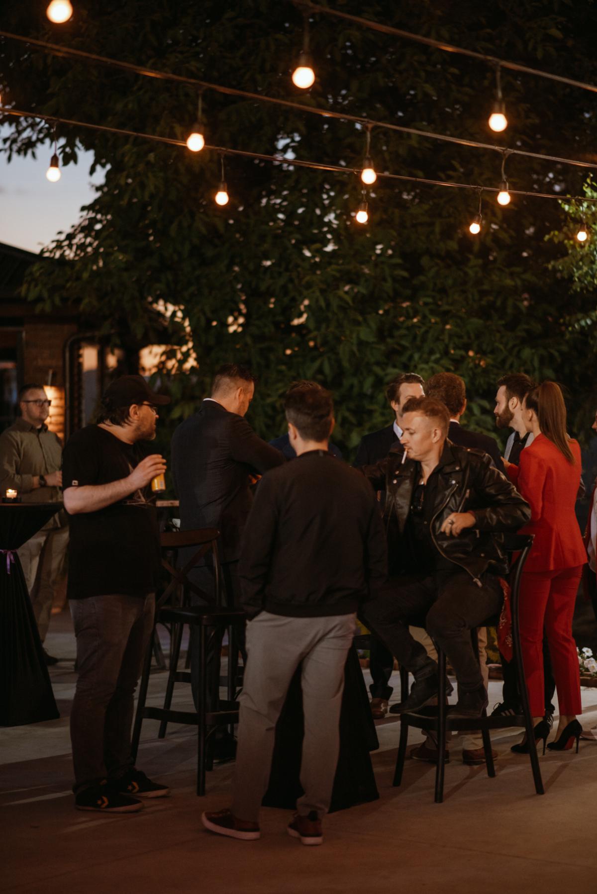 People having a drink and chatting during the founding anniversary party.