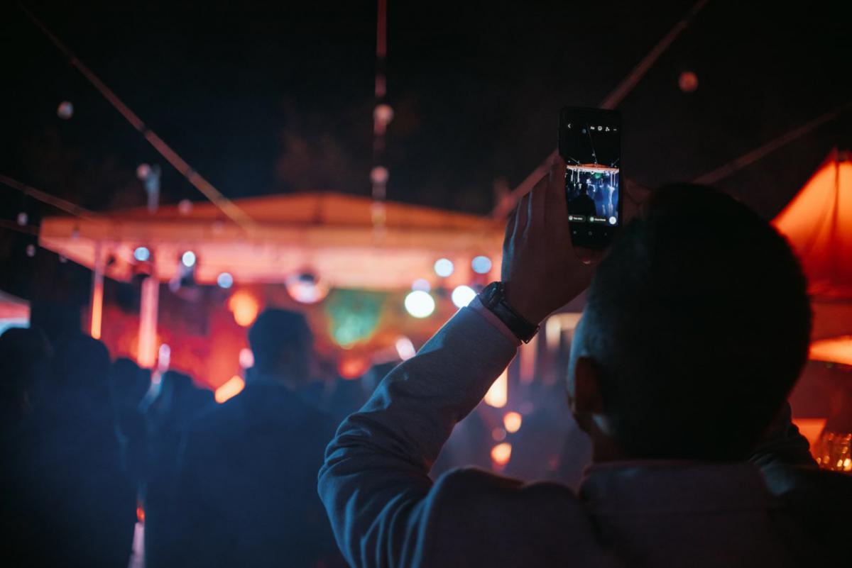 A person taking a photo of the stage.