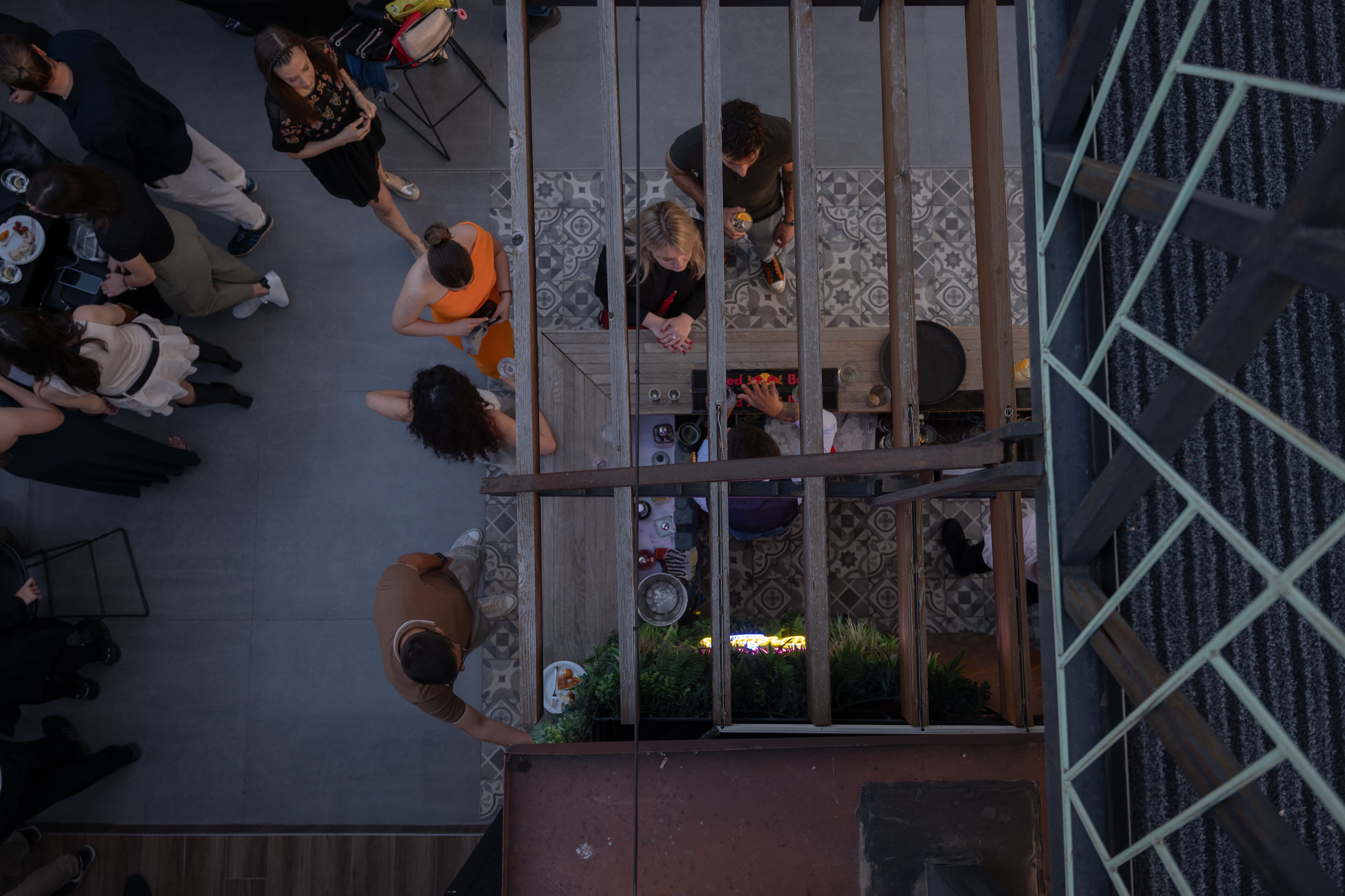 People at a bar ordering a drink. 